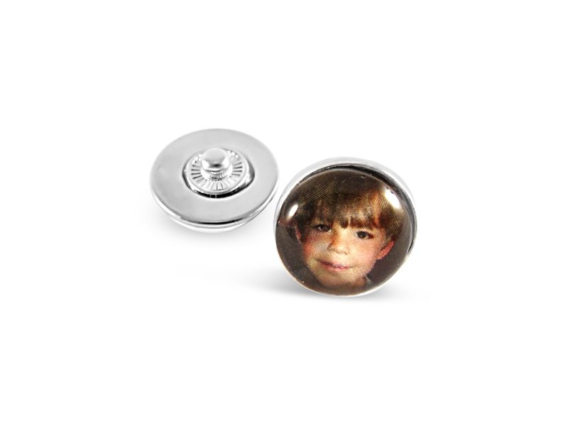 a button with a picture of a boy on it