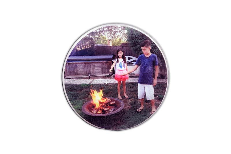 two children standing in front of a fire pit